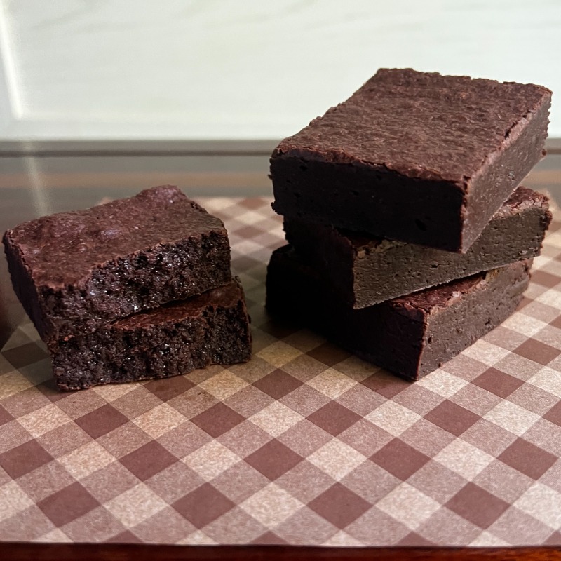 stack of fudgy brownies on parchment