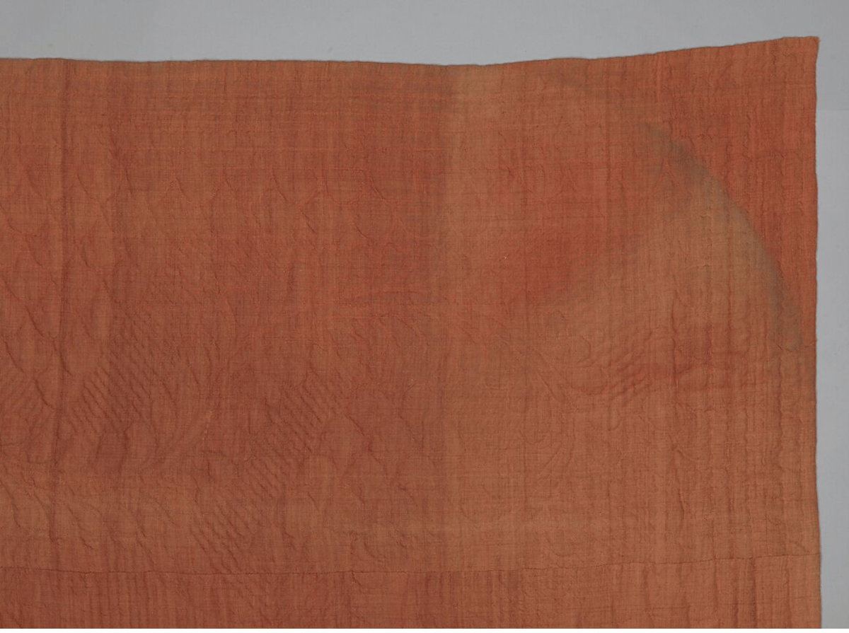 An American whole-cloth quilt made in New England around 1750.