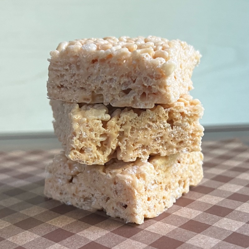 Stack of caramel rice krispie treats on parchment