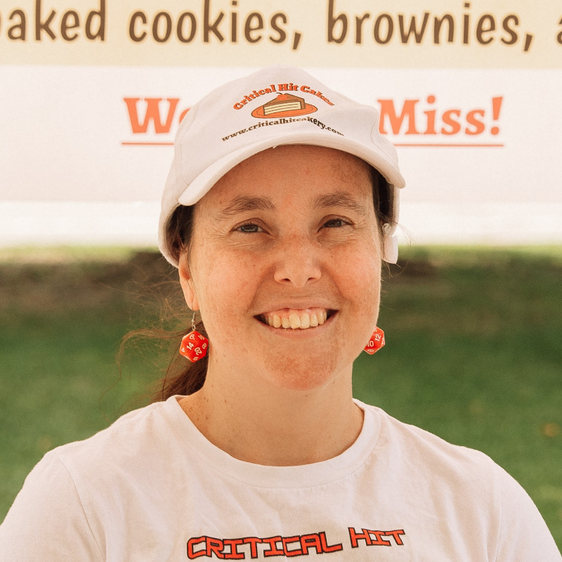 Goofy shot of a woman wearing a company-branded baseball cap