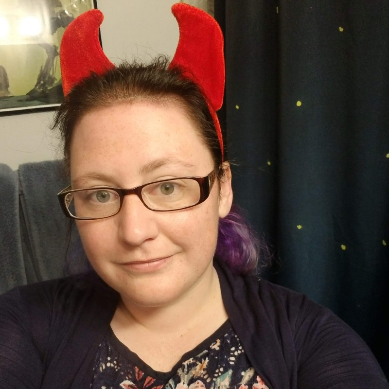 Owner photo in devil horns and blue dress