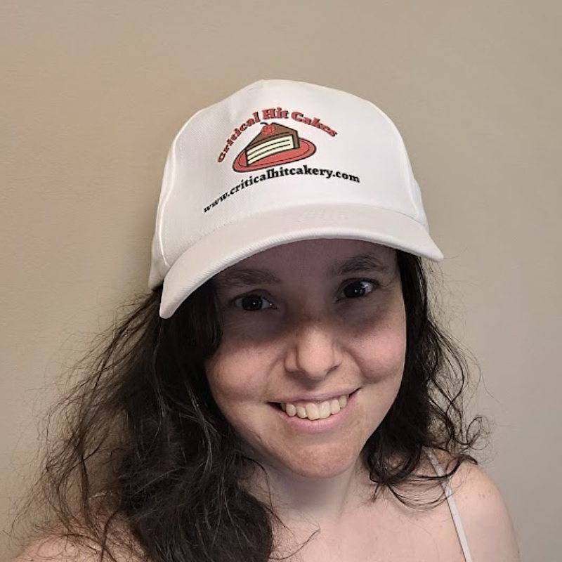 Goofy shot of a woman wearing a company-branded baseball cap