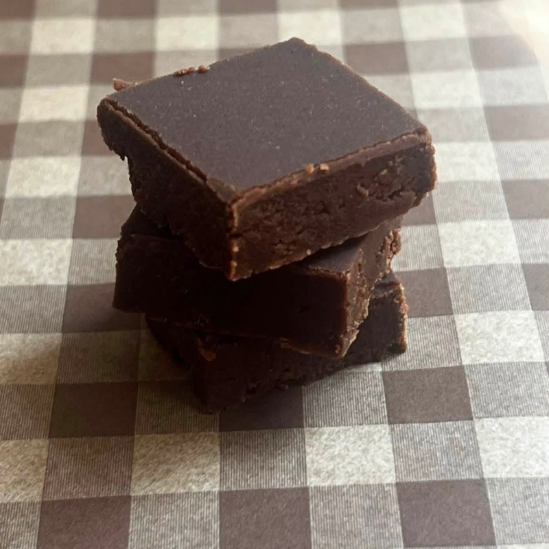 Stack of fudge on checkered parchment paper