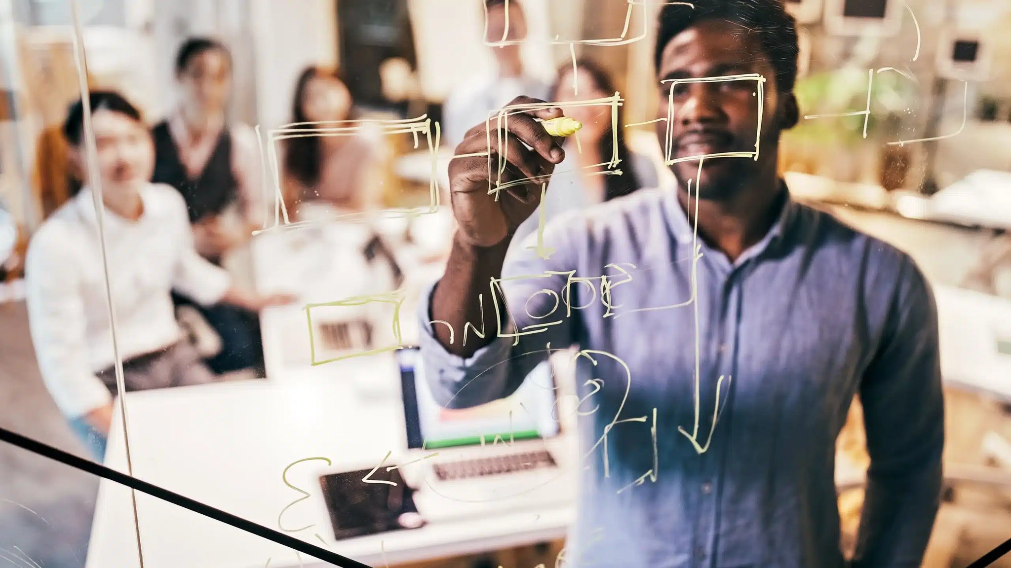 Man drawing on a board for his coaching session