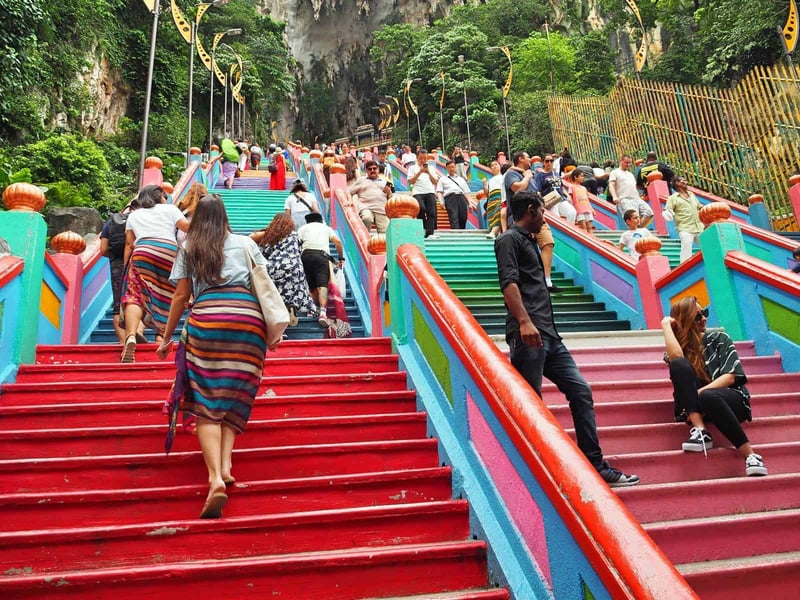 Climbing the stairs at Batu Caves in Kuala Lumpur // Travel Mermaid