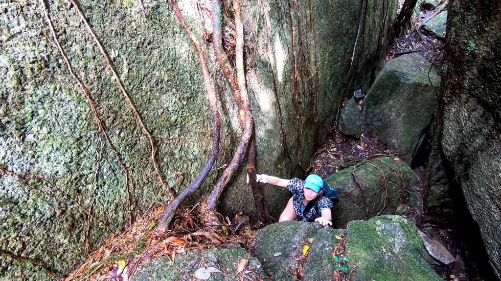 Climbing over Split Rock on The Devil's Thumb hike in Queensland, Australia // Travel Mermaid