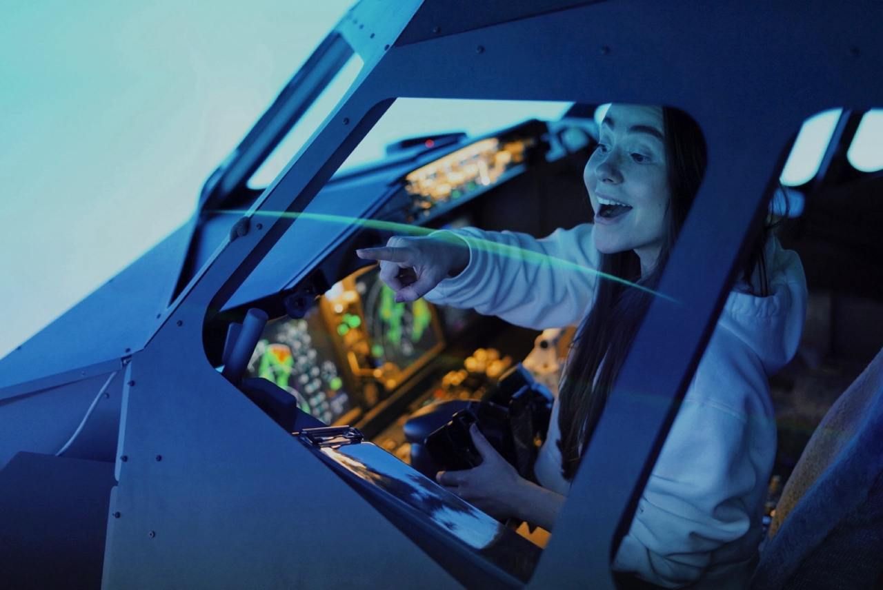 Smiling pilot through the cockpit glass in Boeing 737 simulator