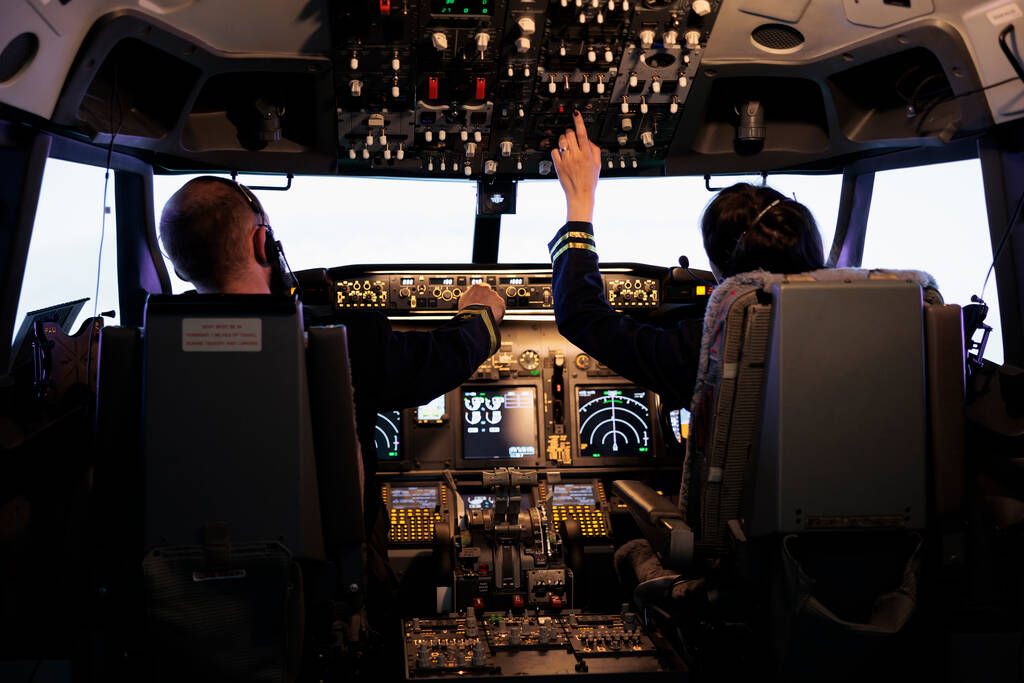 Woman captain and copilot preparing for takeoff in Boeing 737 simulator