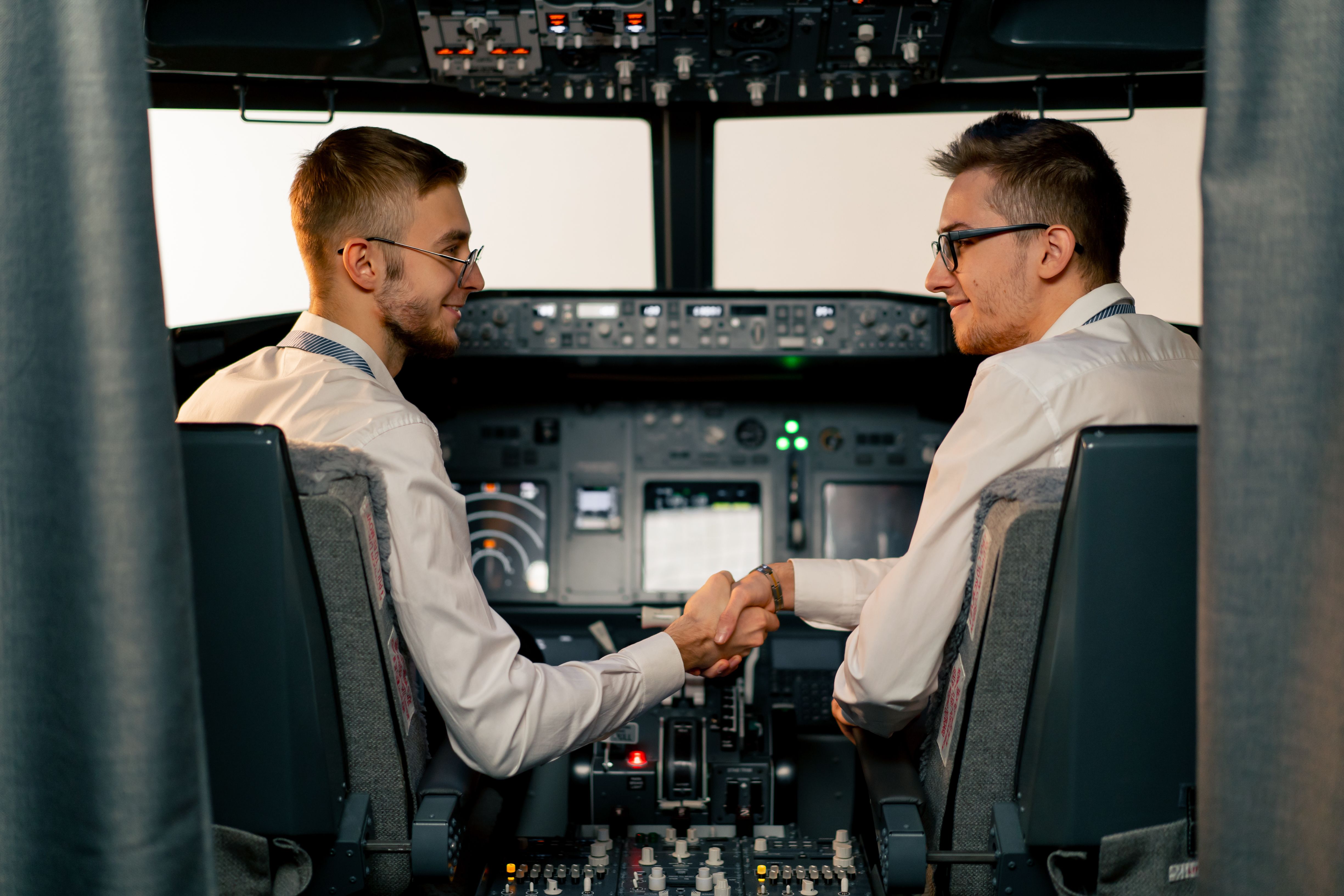 Two pilots communicating during Boeing 737 simulator training session