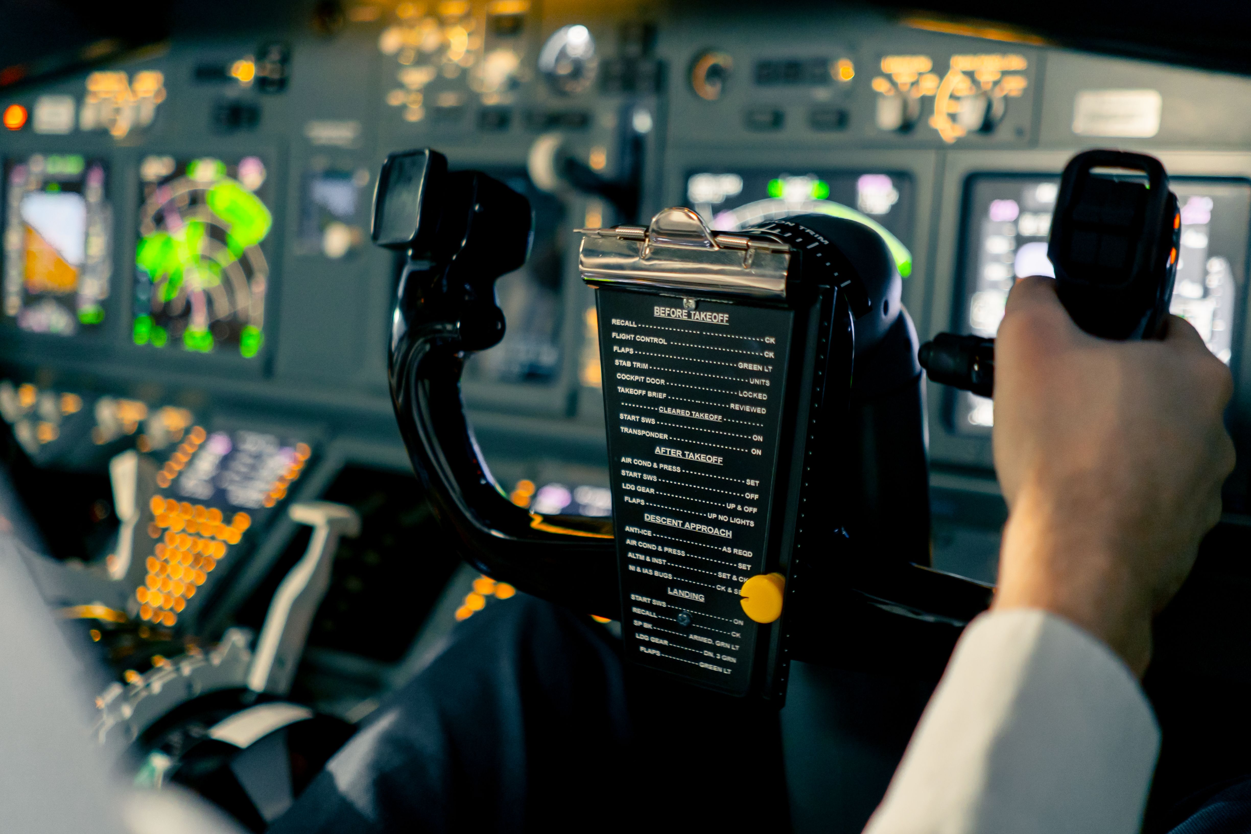 Pilot controlling navigation displays in Boeing 737 simulator