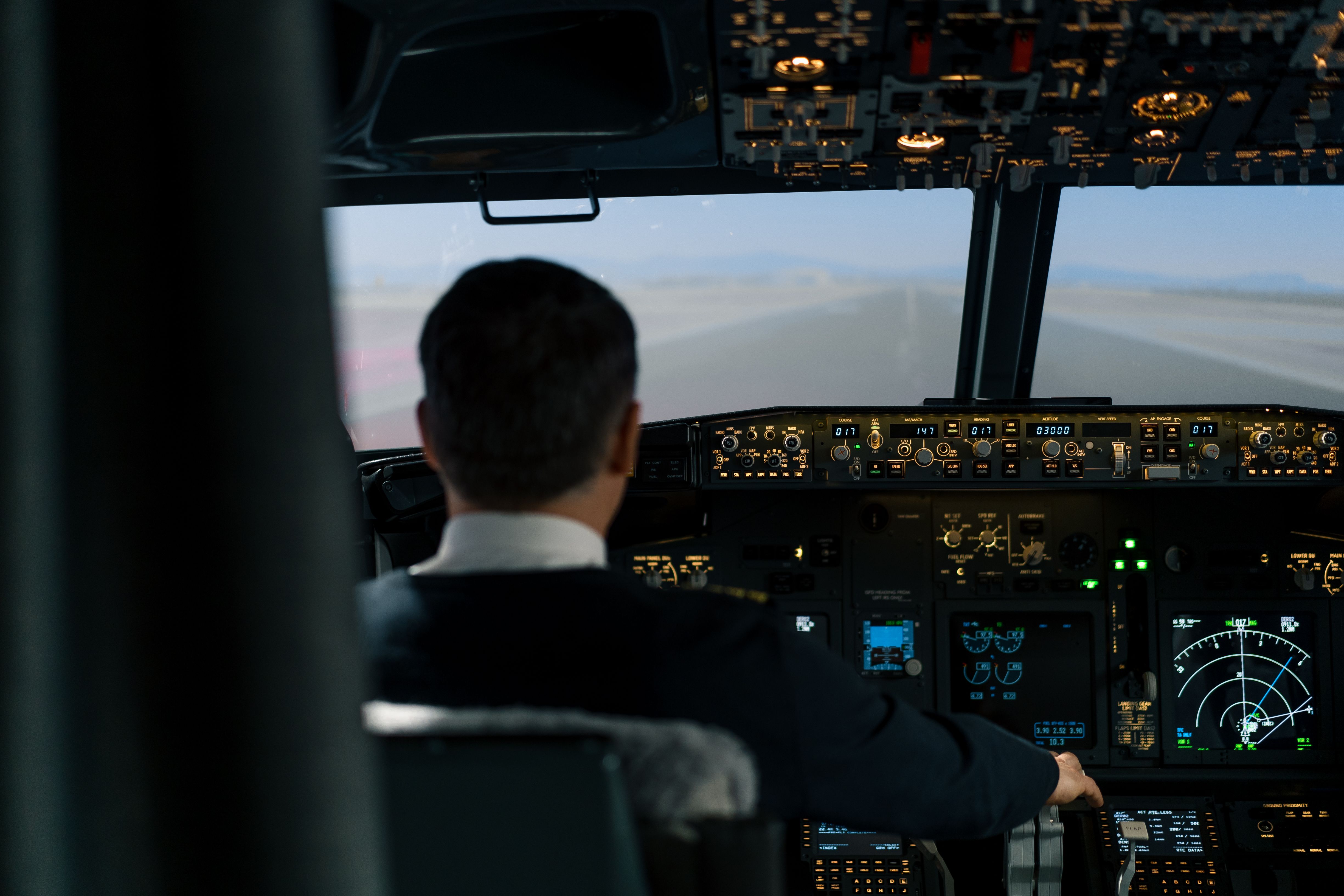 Pilot operating Boeing 737 simulator controls