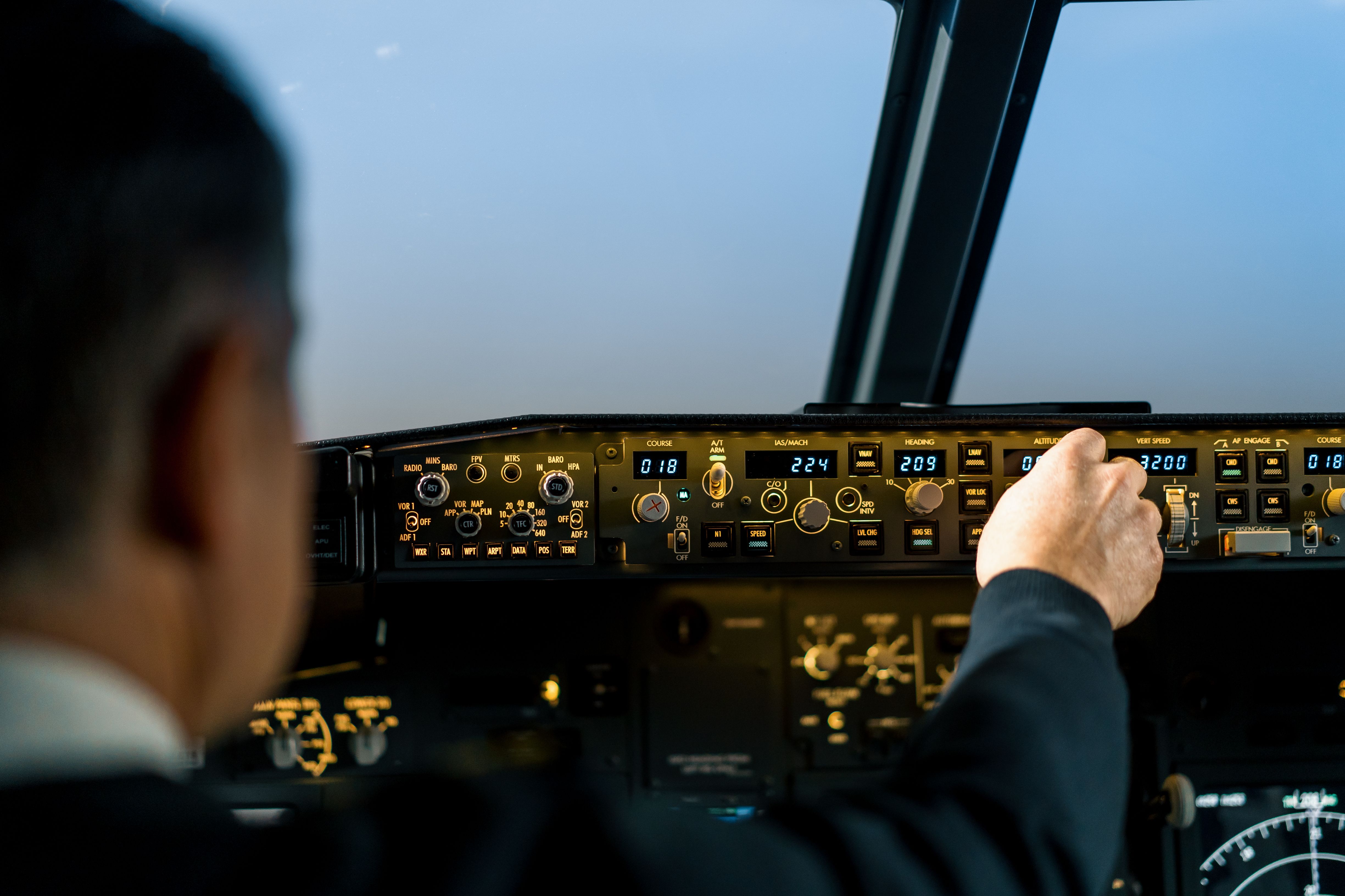 Pilot operating autopilot controls in Boeing 737 simulator