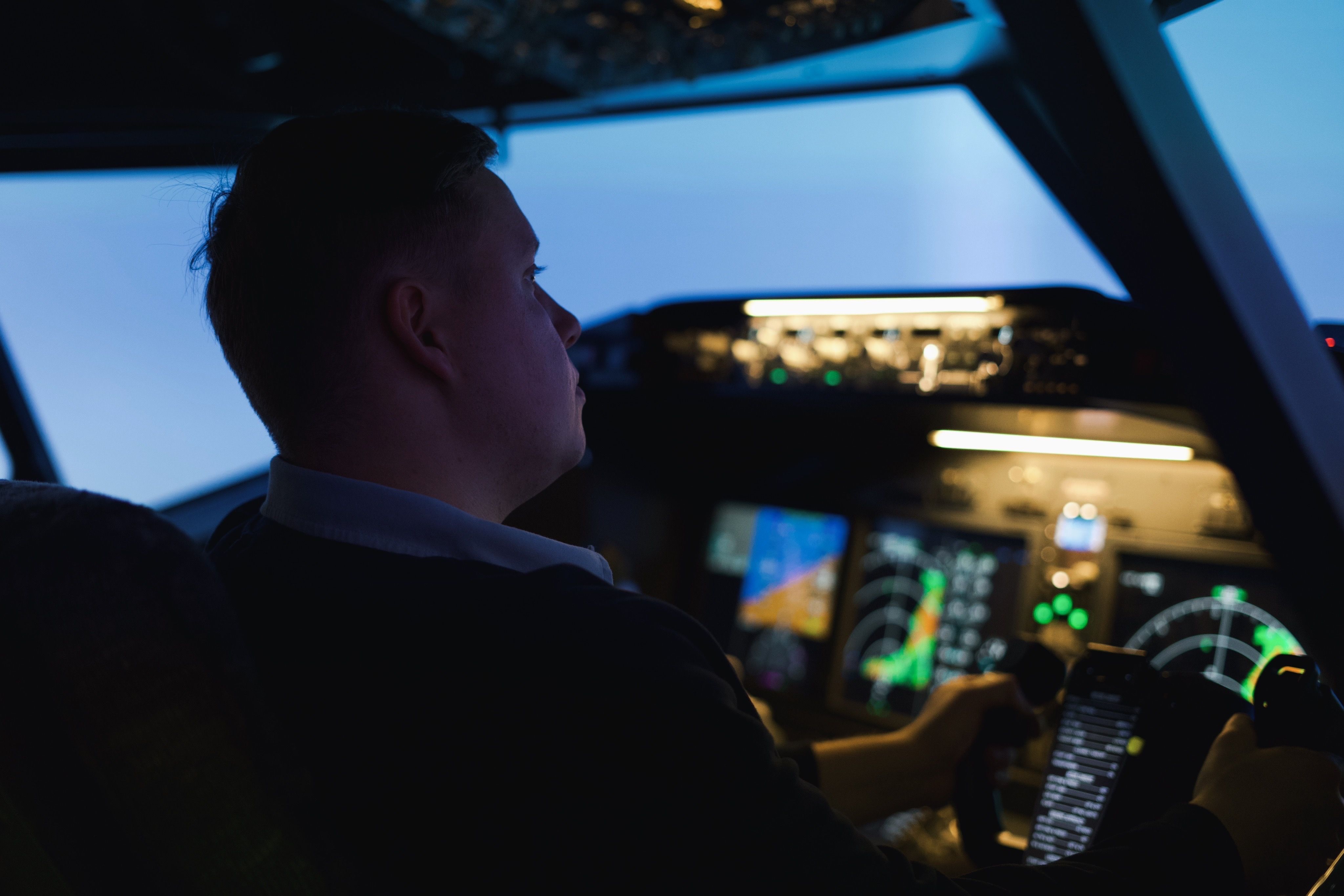 Man sitting in Boeing 737 simulator cockpit