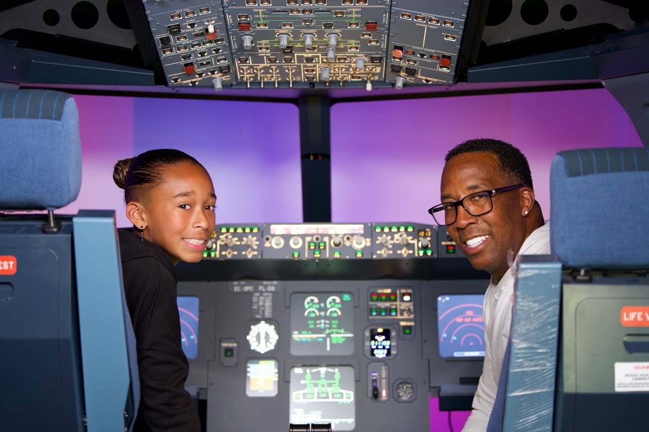 Happy customers smiling in Airbus A320 simulator cockpit
