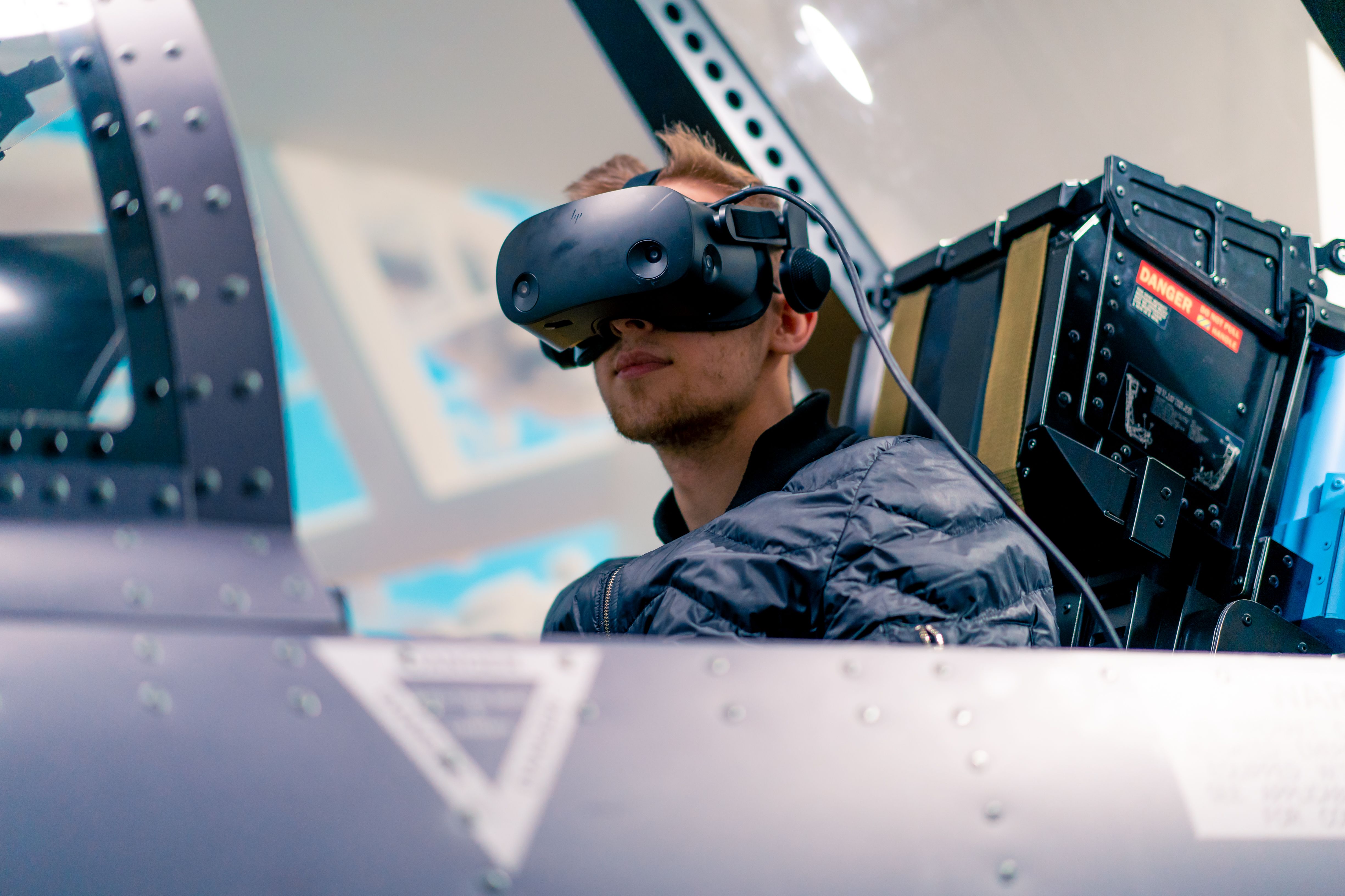 Pilot wearing virtual reality helmet in F/A-18 Hornet simulator