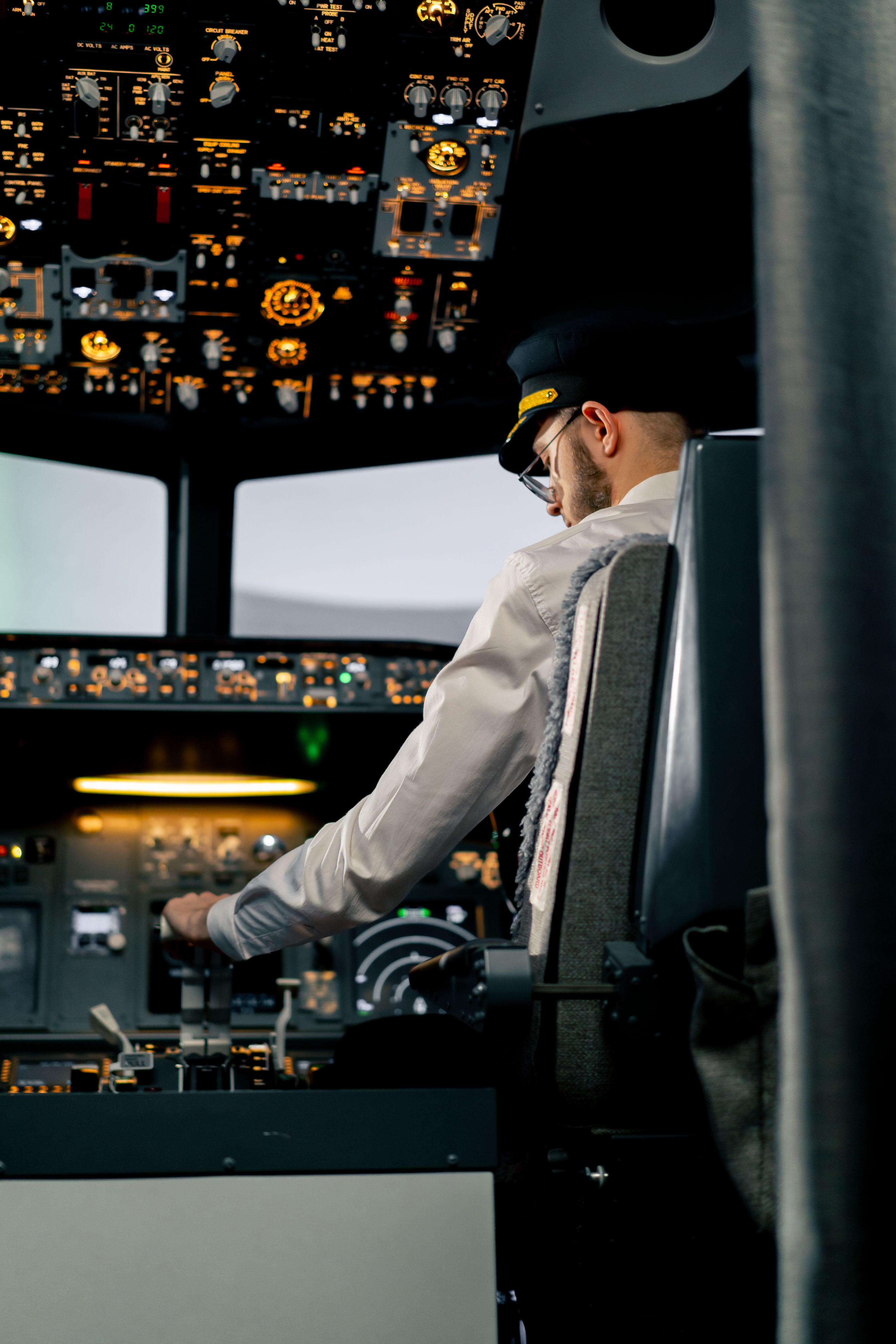 Pilot adjusting systems in Boeing 737 simulator