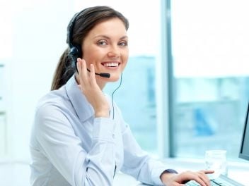 Person on headset attending to queries