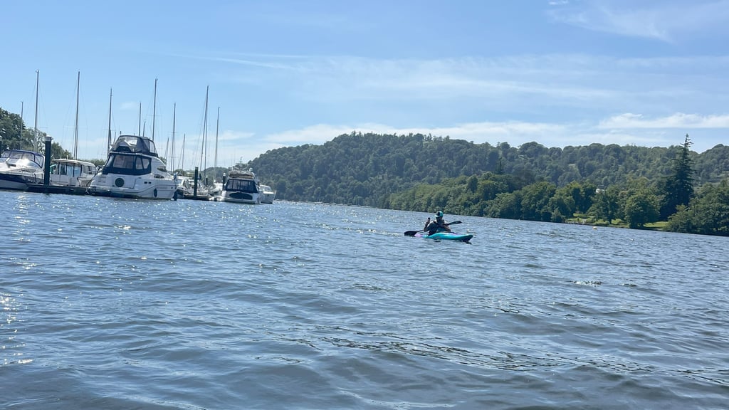 Paddler on Windermere with boats in the background