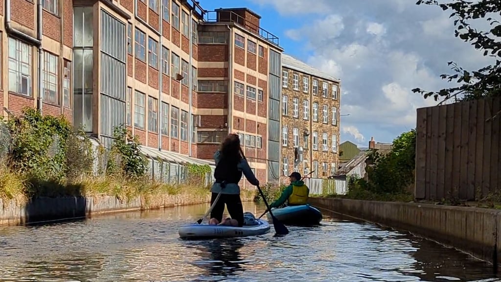 Paddling the Peak Forest Canal near buildings