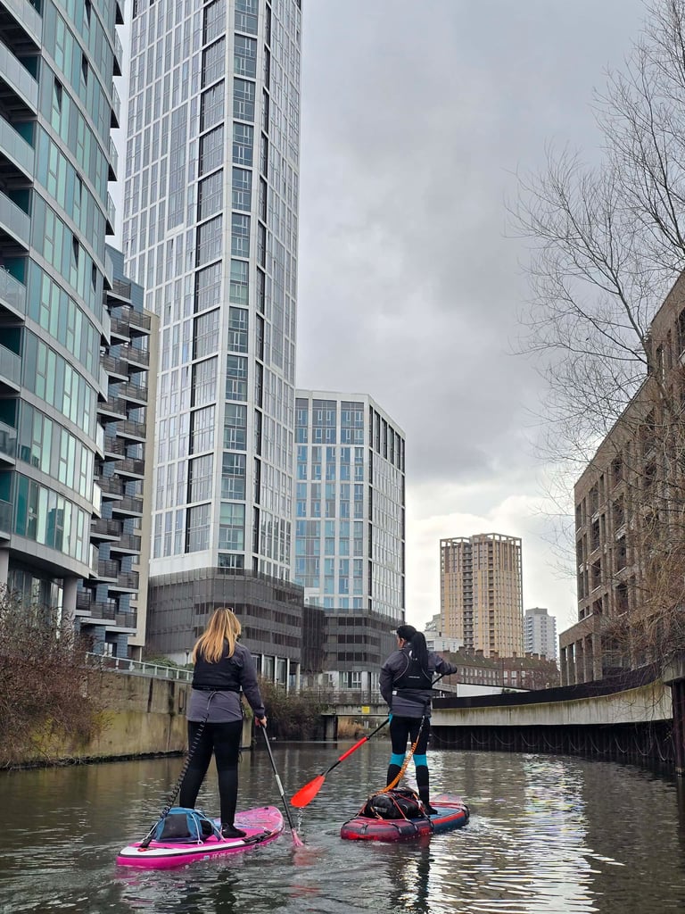 Two female paddleboarders at St Thomas Creek