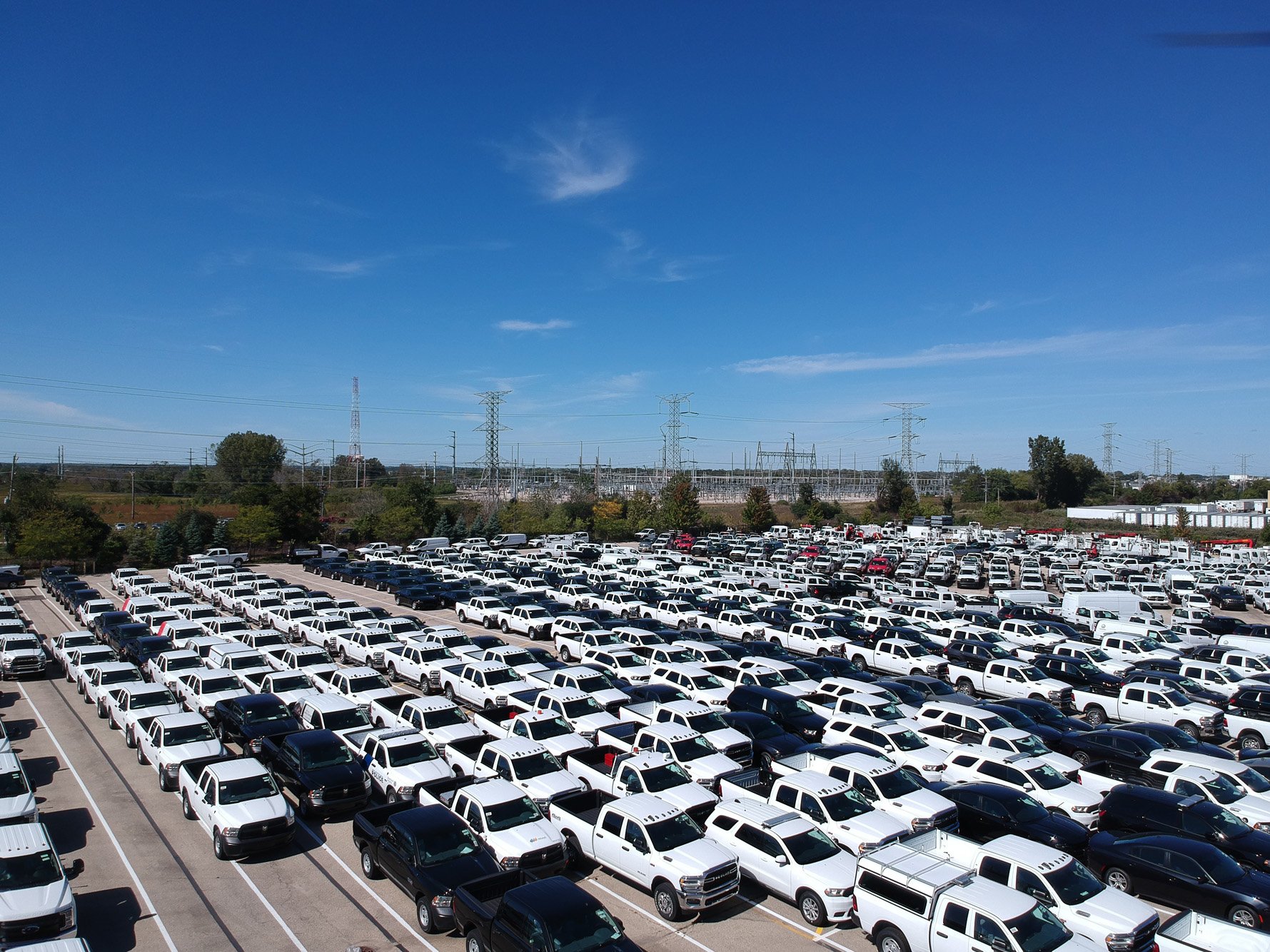a large parking lot full of white cars
