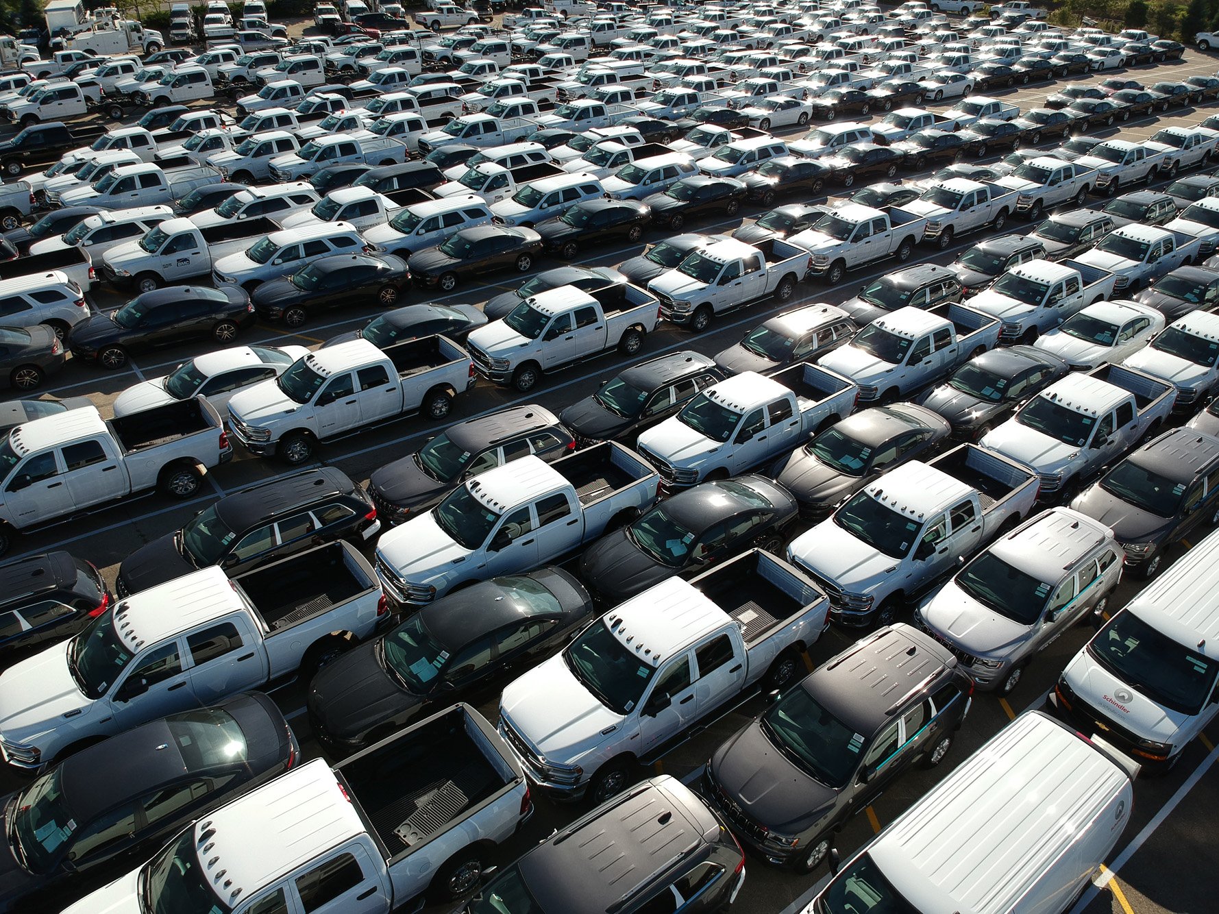 a large group of cars parked in a parking lot
