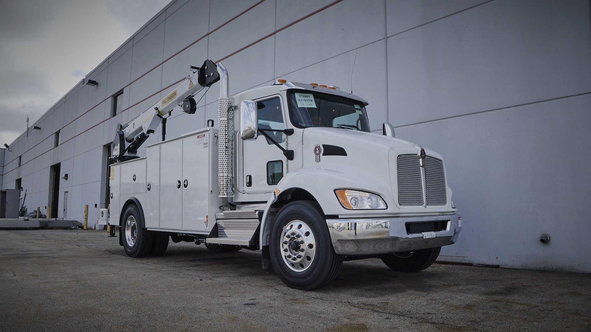 a white truck with a crane on the side