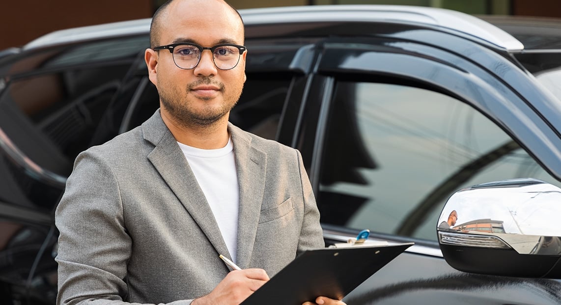 a man holding a clipboard and pen