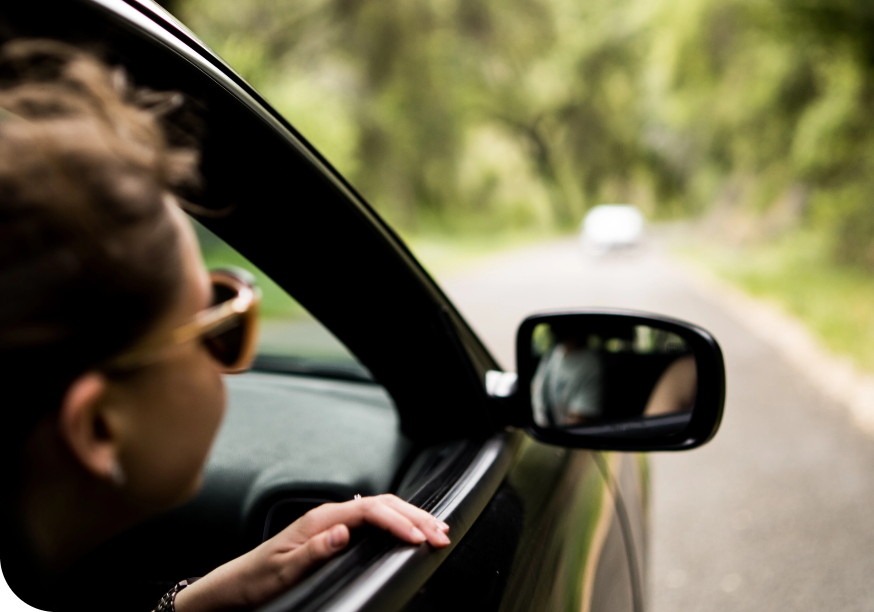 a woman looking out of a car window