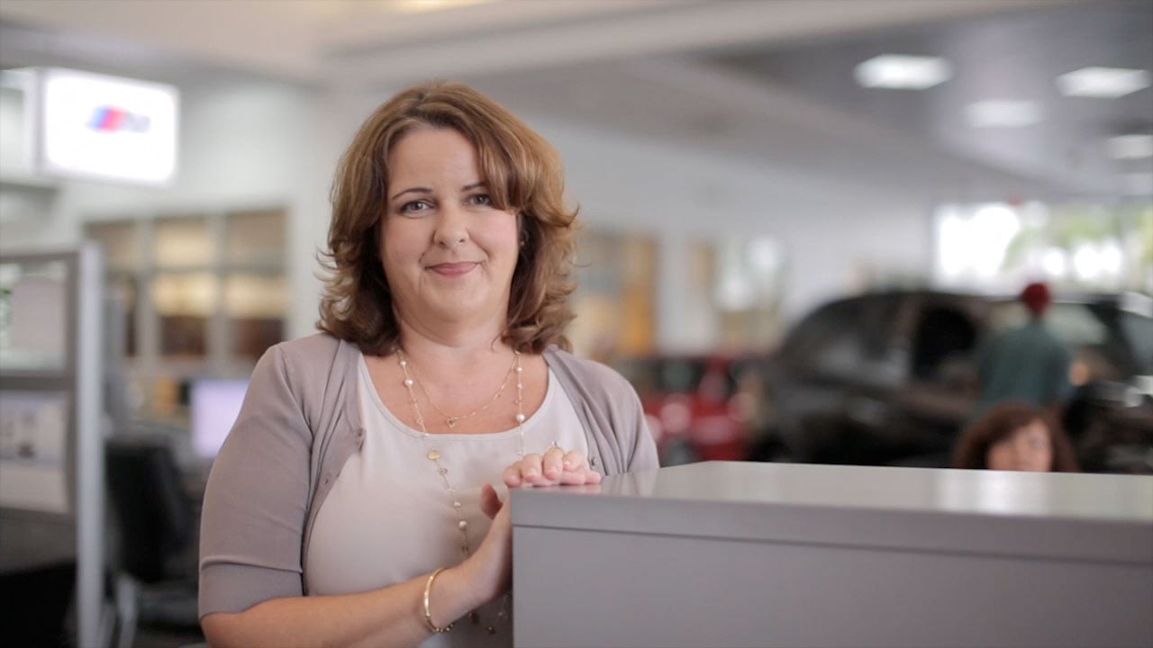 Woman leaning on the counter smiling