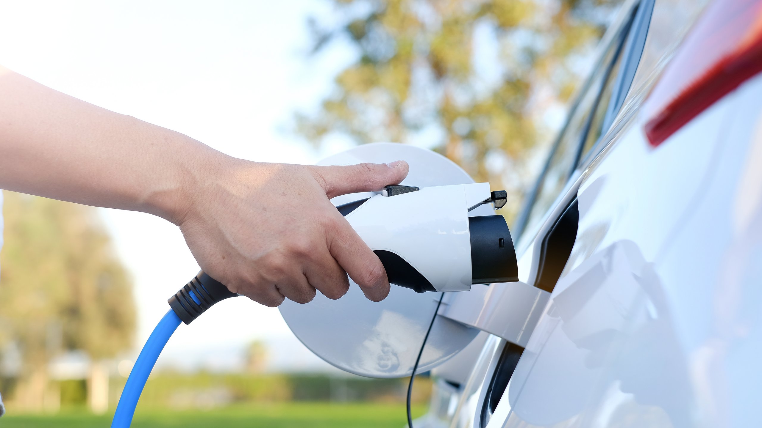 Person trying to connect the electric vehicle charger