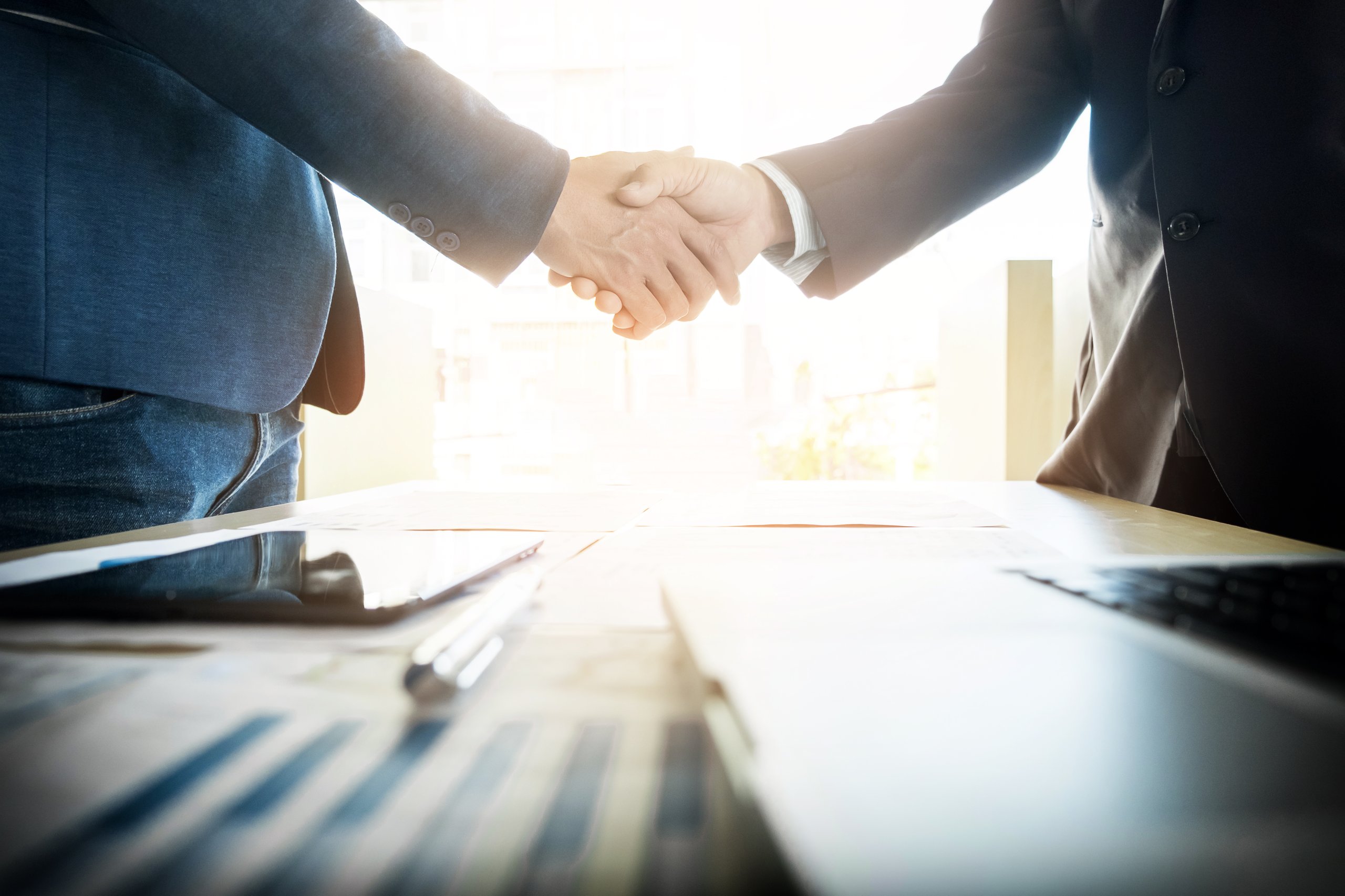 2 people handshaking in the office