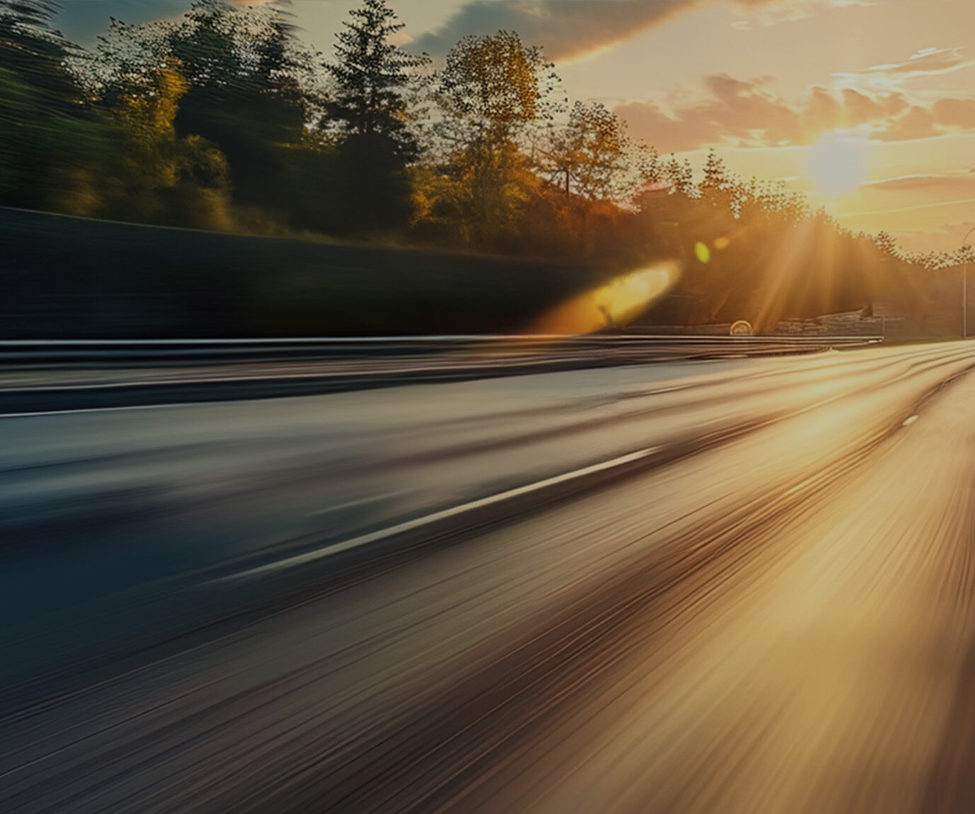 a blurry road with trees and sun