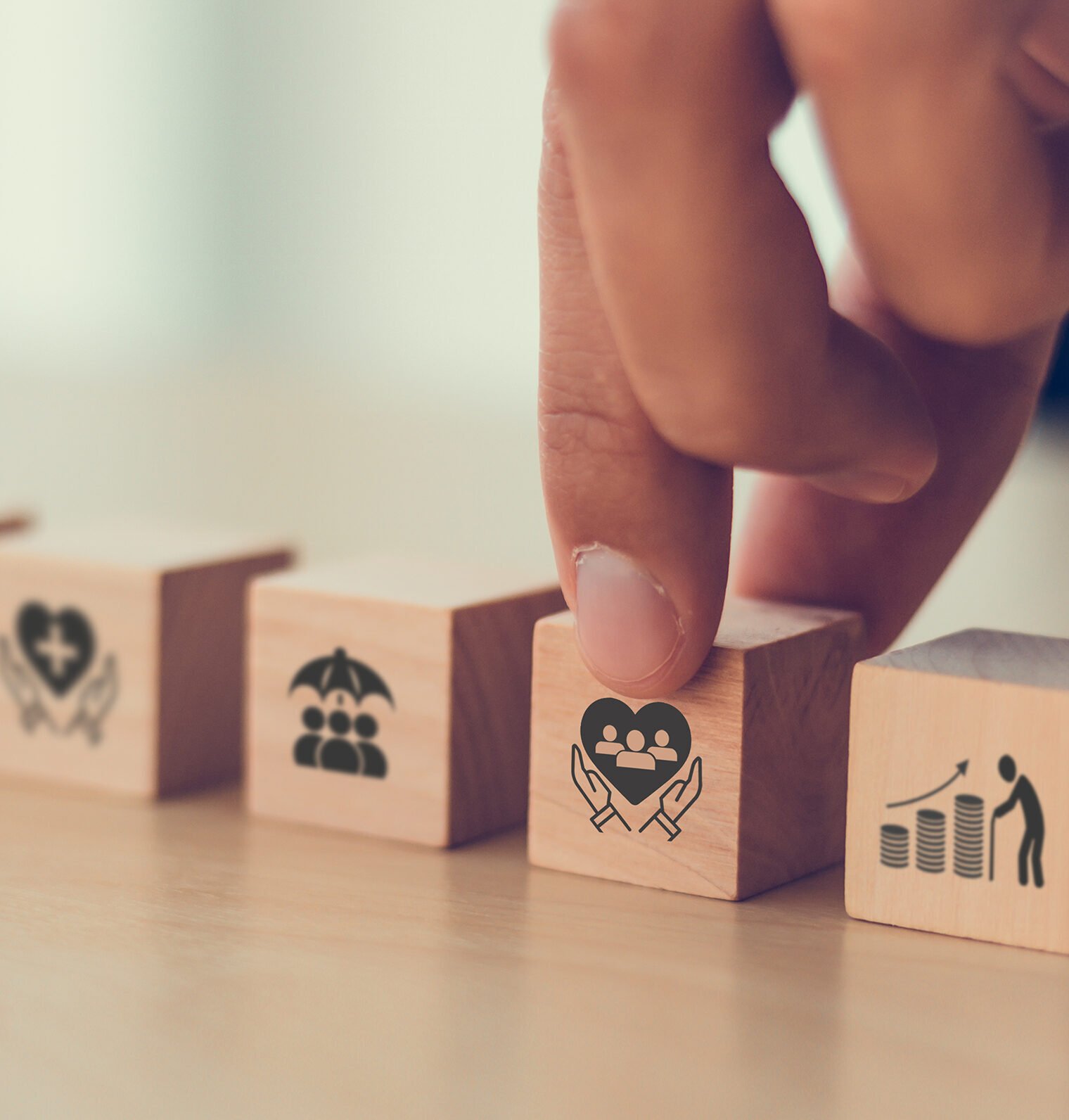 a finger touching a wooden block