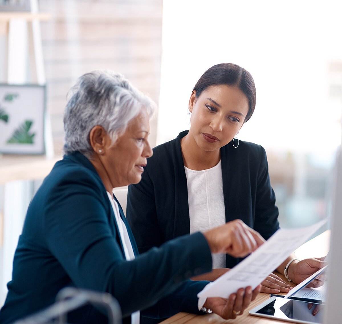 a woman showing a piece of paper to a woman