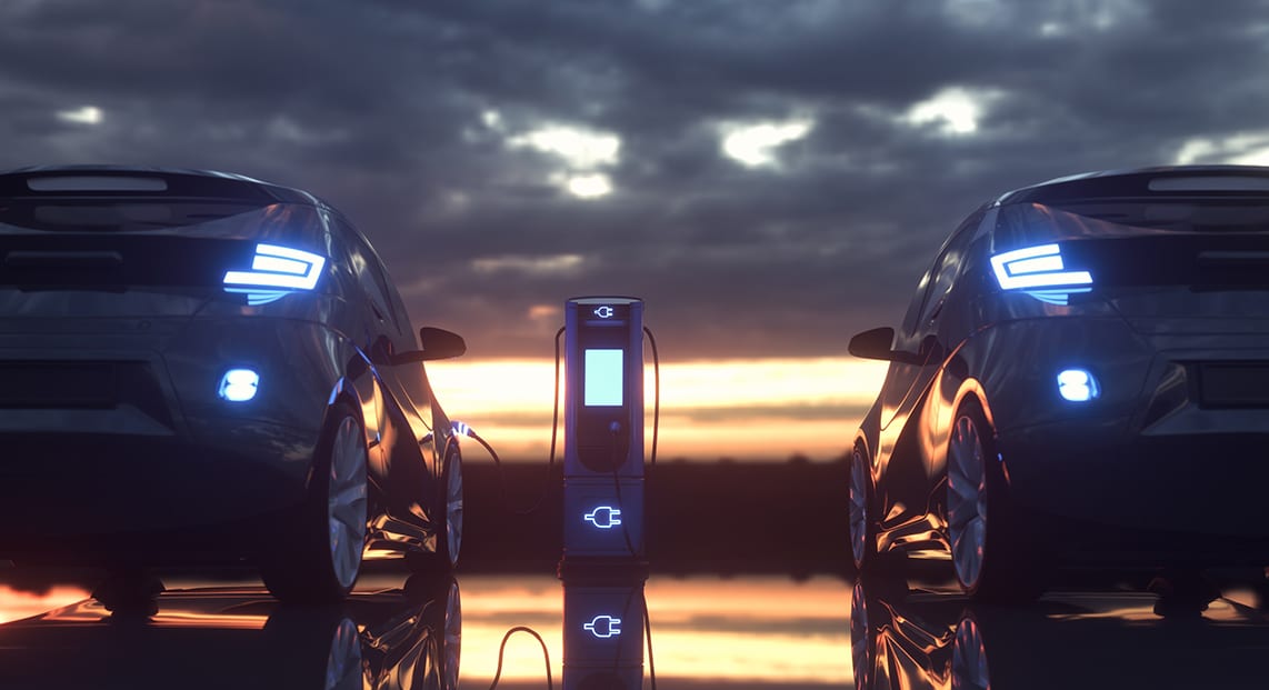 a two cars charging at a charging station