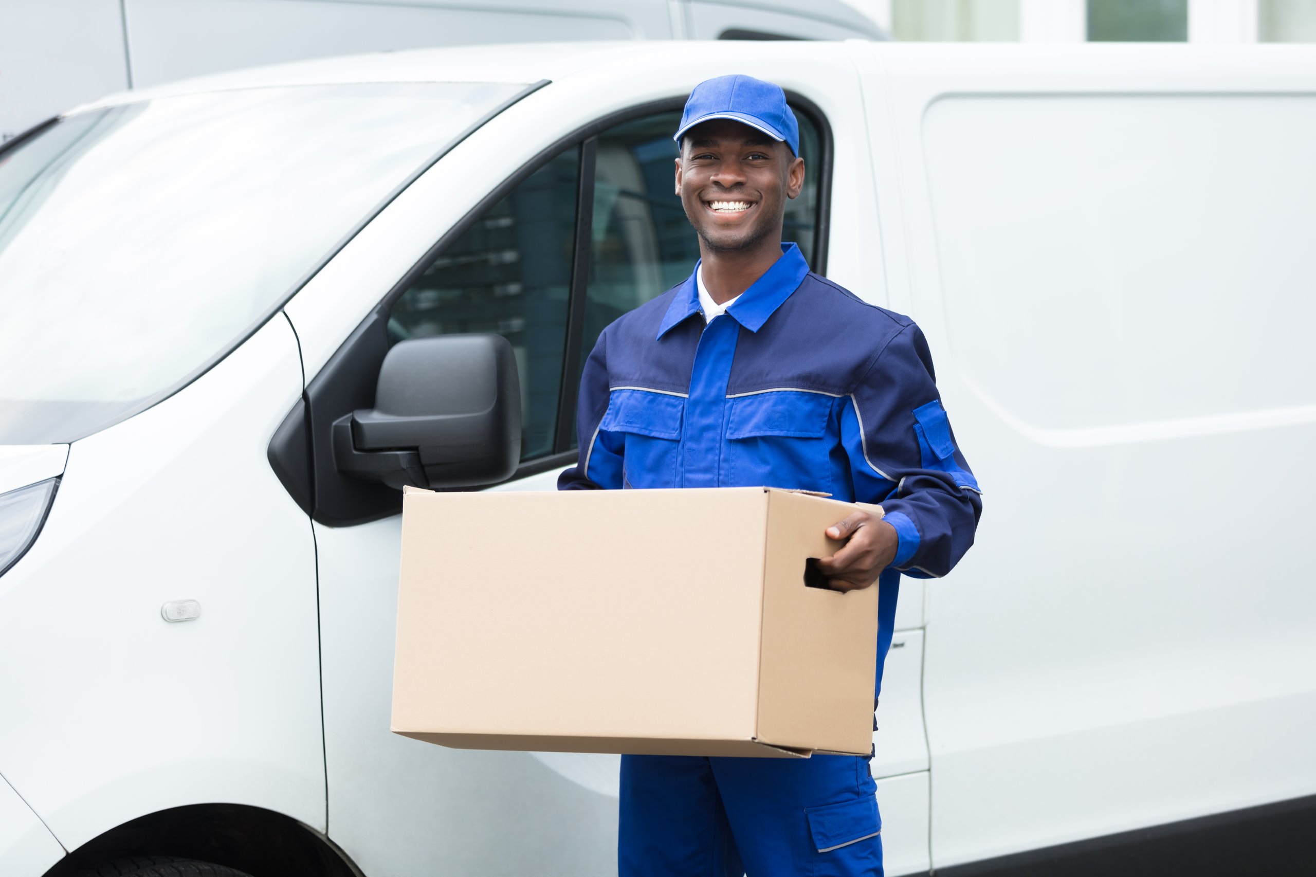 Picture of a Holman employee holding a package