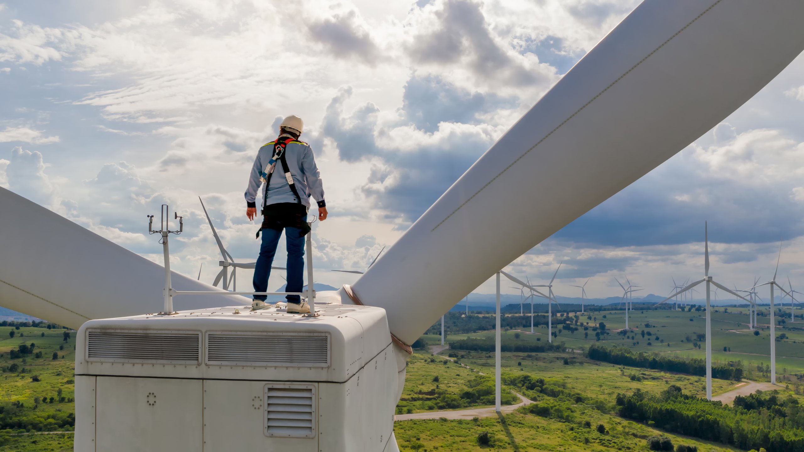 Holman employee standing on top of a wind turbine