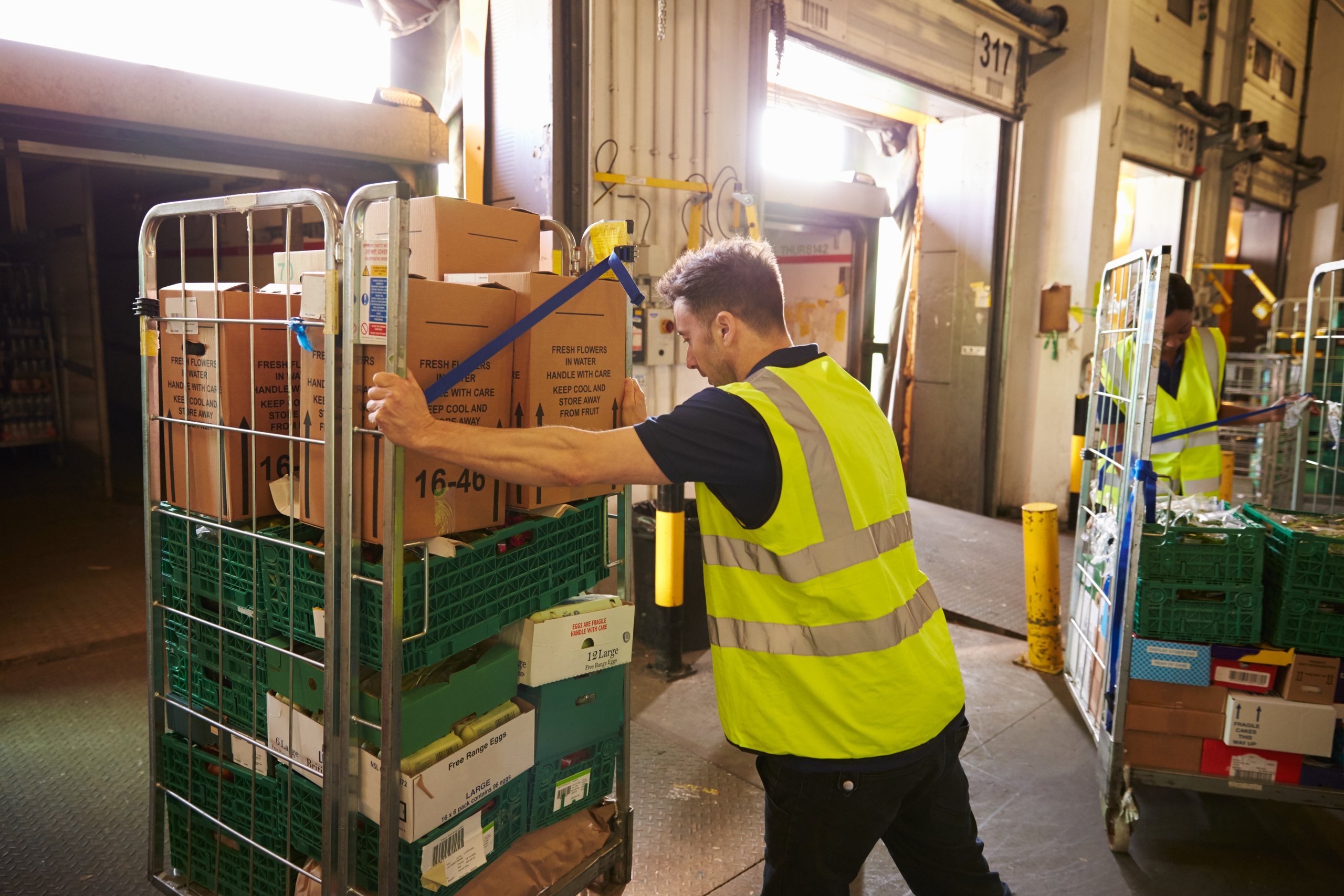 Man pushing a cart of boxes
