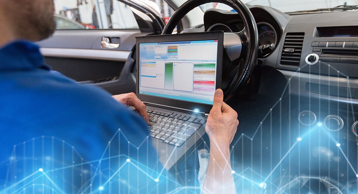 a person using a laptop in a car