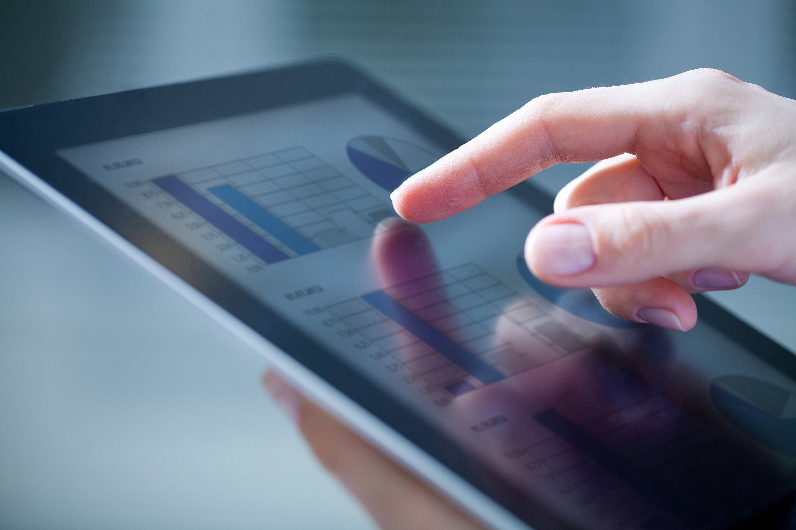 Woman pointing at a data graph on the tablet