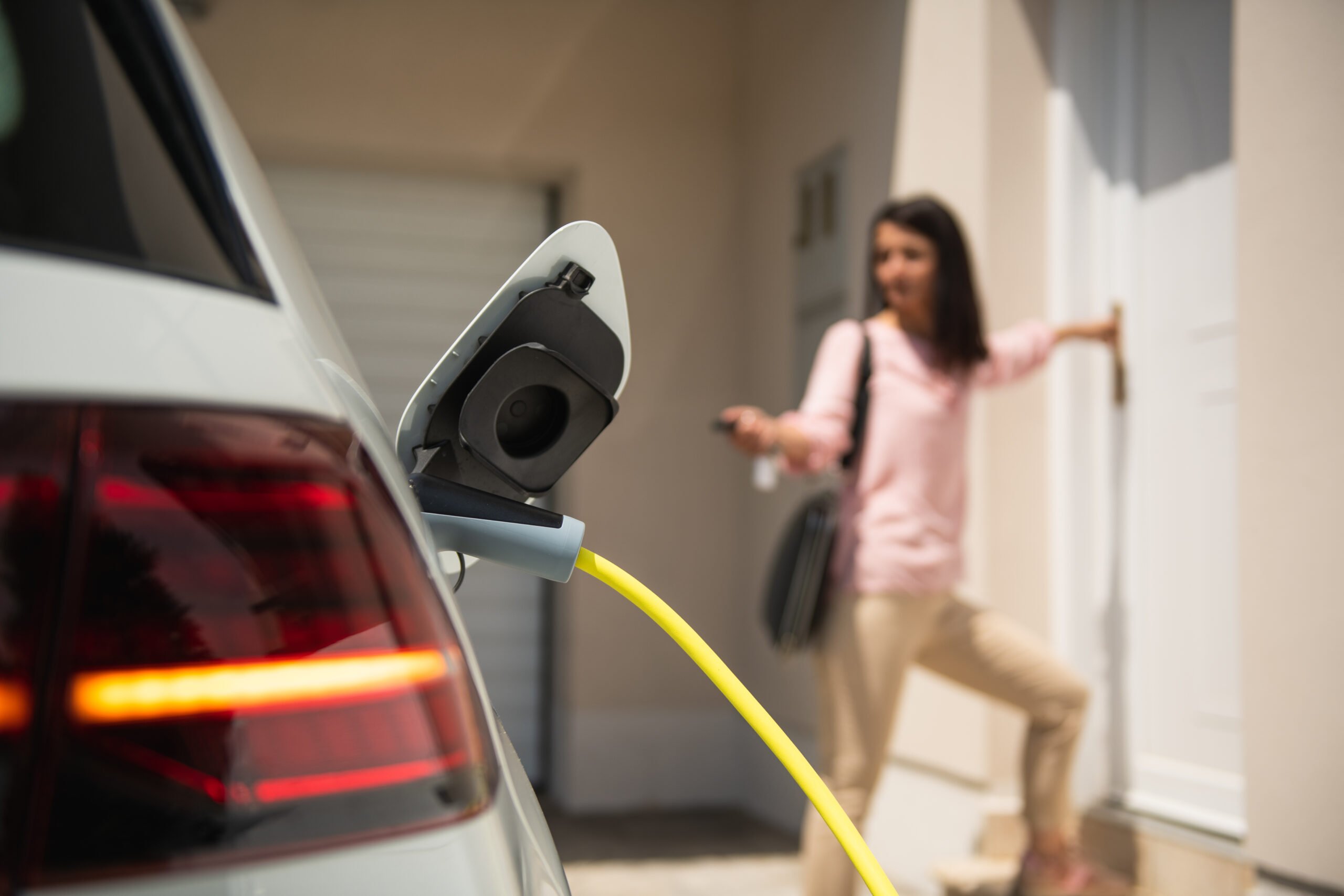a woman standing in front of a car