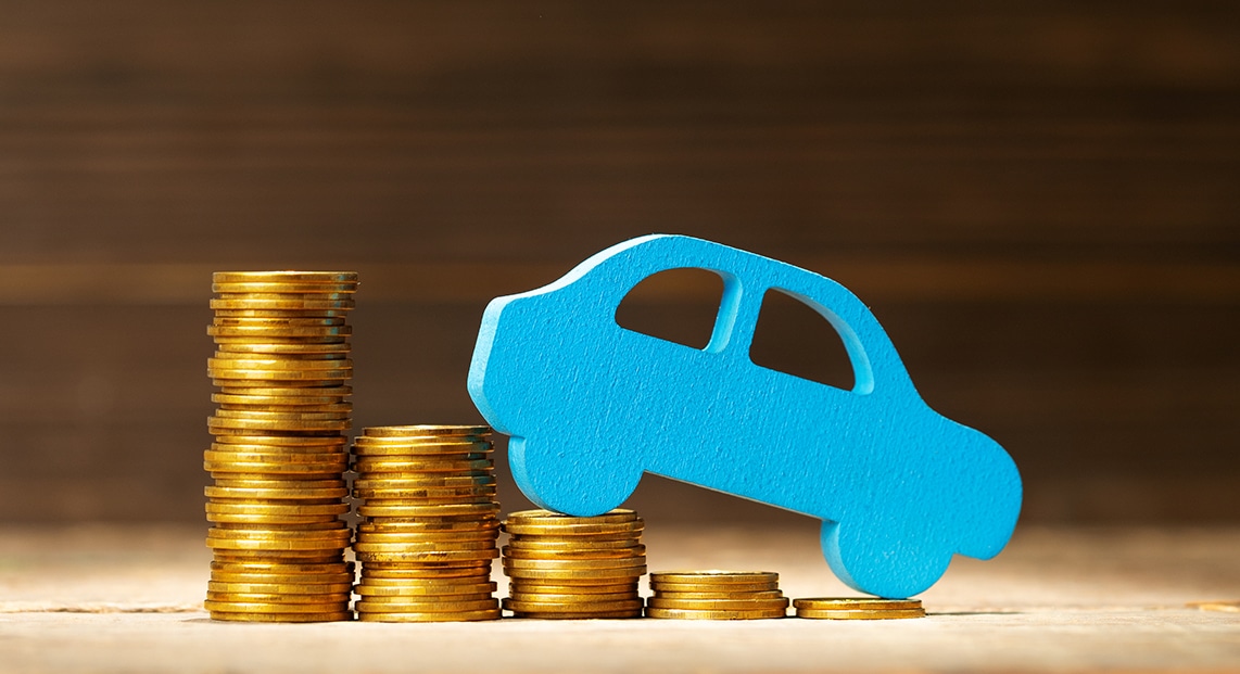 a blue toy car on top of stacks of coins