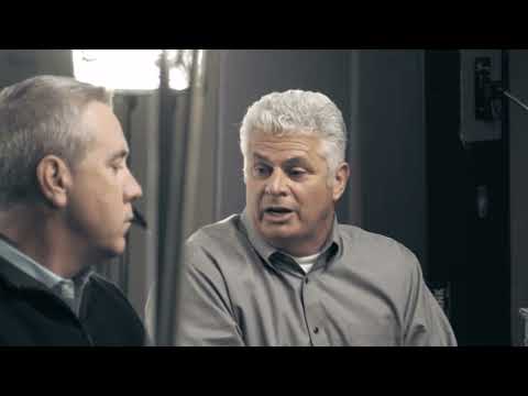 a man talking to another man