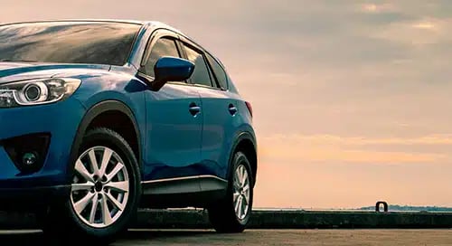 a blue car parked on a road