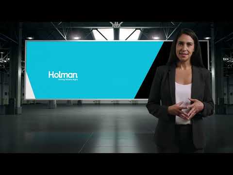 a woman standing in front of a large screen