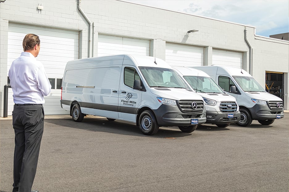 a group of white vans in a row