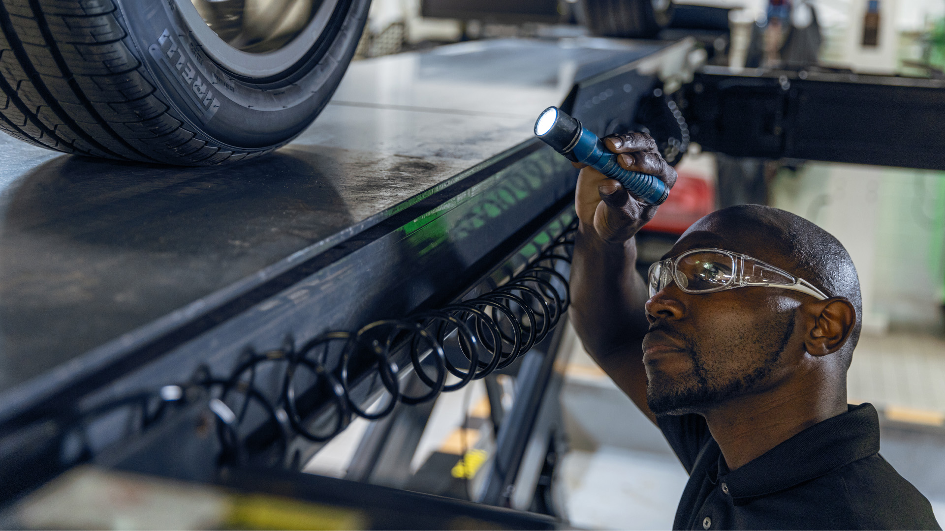 a man wearing safety glasses and holding a flashlight