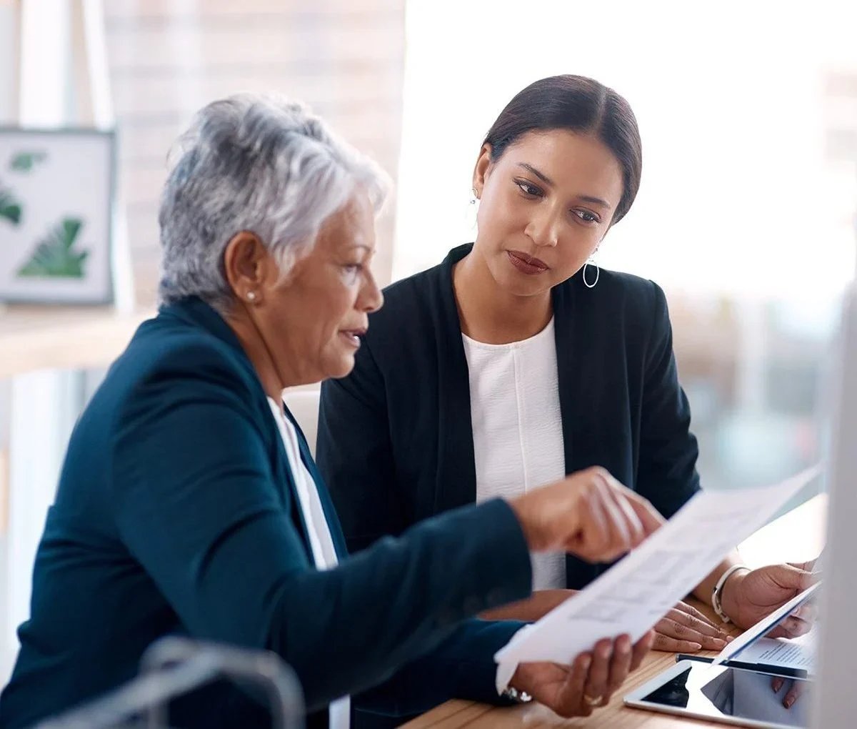 a woman showing a piece of paper to a woman