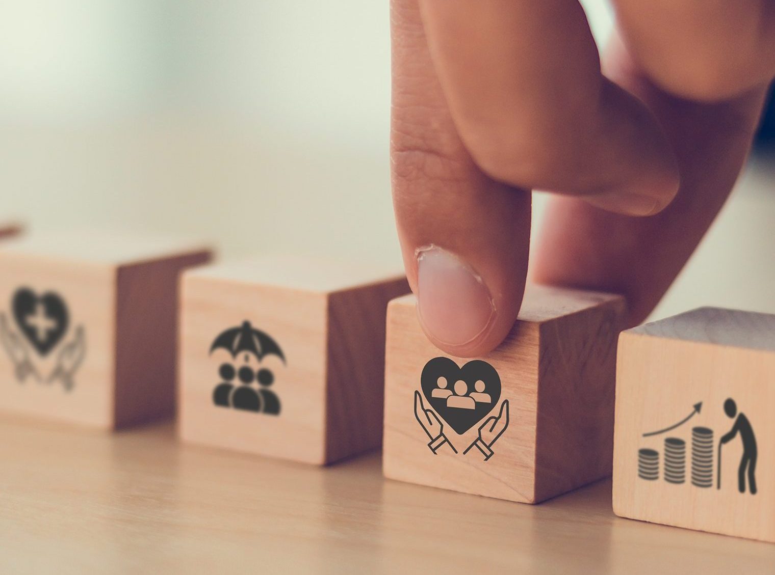 a finger touching a wooden block